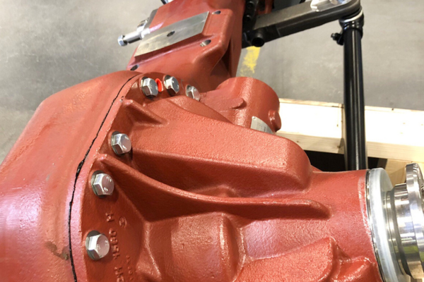 red gear, pump housing, bolted flange, machined metal, industrial component