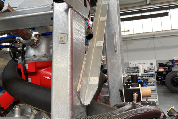 engine, metal frame, red component, hose, industrial machinery